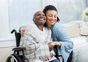 Daughter hugging mother in wheelchair