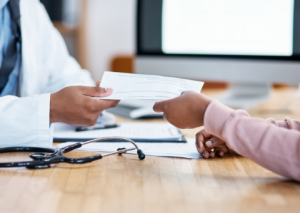 Doctor handing paperwork to patient