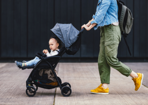 Woman pushing stroller with toddler