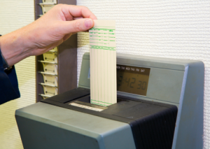 Employee punching in with time card