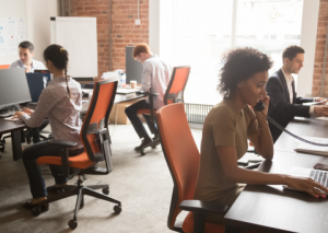 Workers at desks in open office building