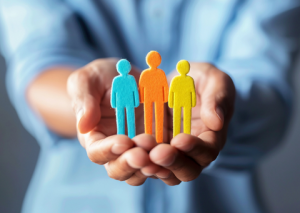 Hands outstretched with three paper people