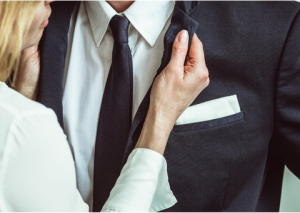 Women looking at husband's lapel for lipstick