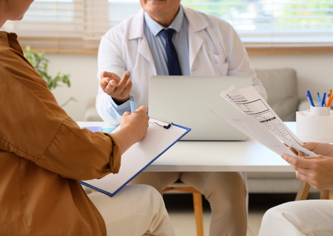 Fertility patients filling out paperwork and speaking to doctor