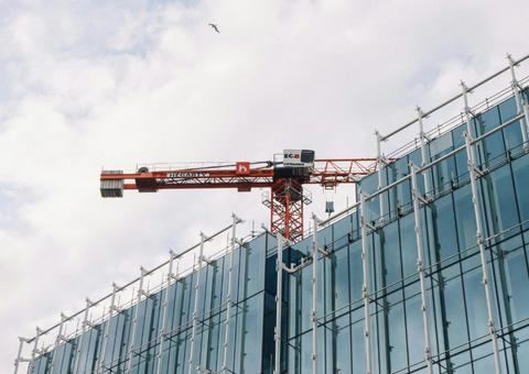 Crane on top of highrise office building