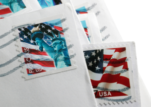 US stamps on pile of envelopes